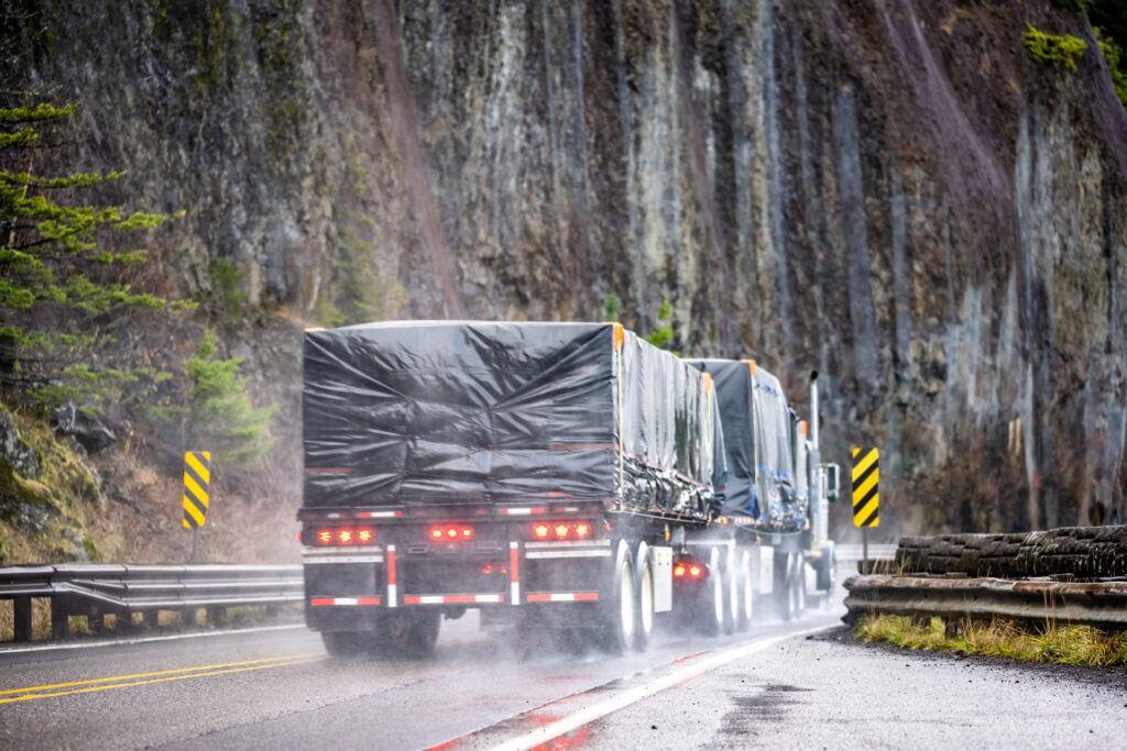 Flatbed truck driving in the rain