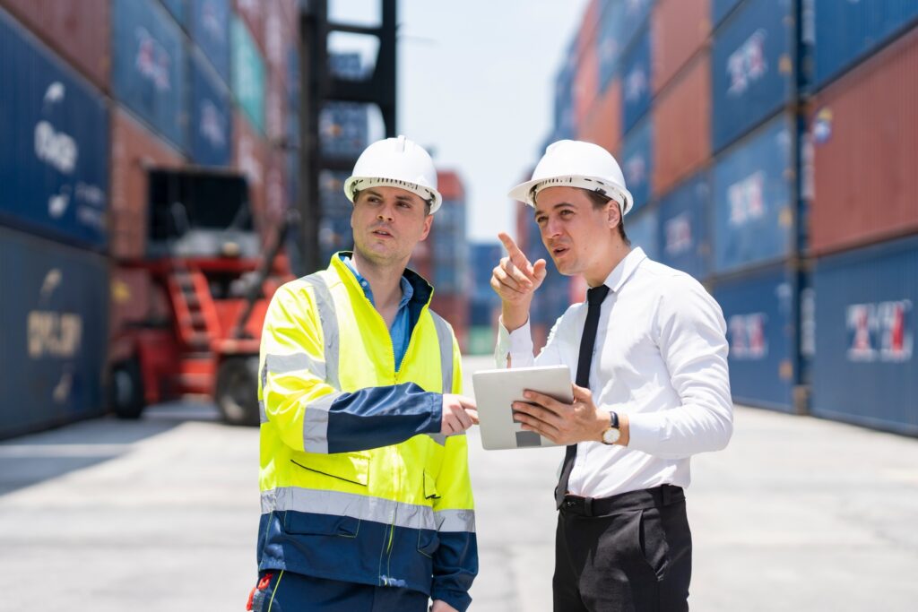 Customs inspector talking to dock worker